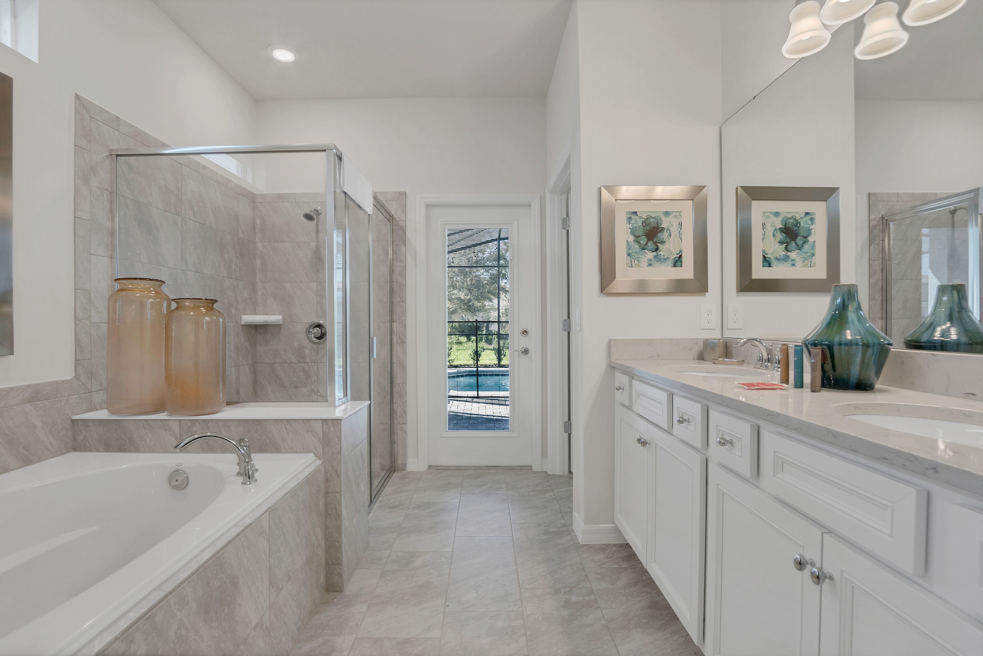 A modern bathroom with a glass-enclosed shower, a bathtub, and a vanity with a large mirror.
