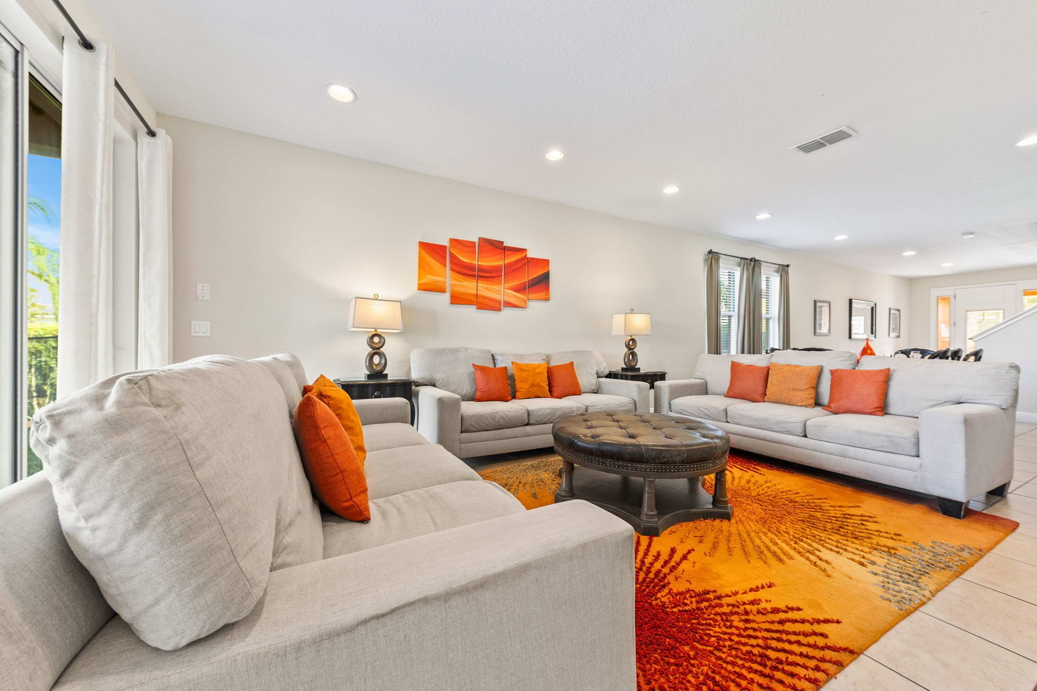 A modern living room with two sofas, a coffee table, and a rug.
