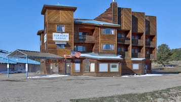 A multi-story wooden building with a sign reading 'ELK HORN LODGE'.