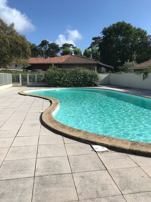 Relax by the serene pool surrounded by a beautifully maintained garden and rustic charm.