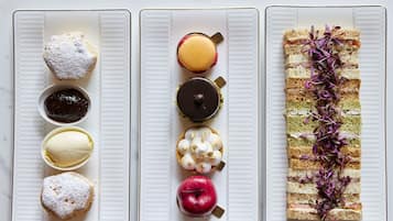 Three rectangular plates with various food items.