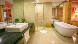 A modern bathroom with a large bathtub, a glass shower enclosure, and a dual sink vanity. - Boyue Hotel (Changchun)