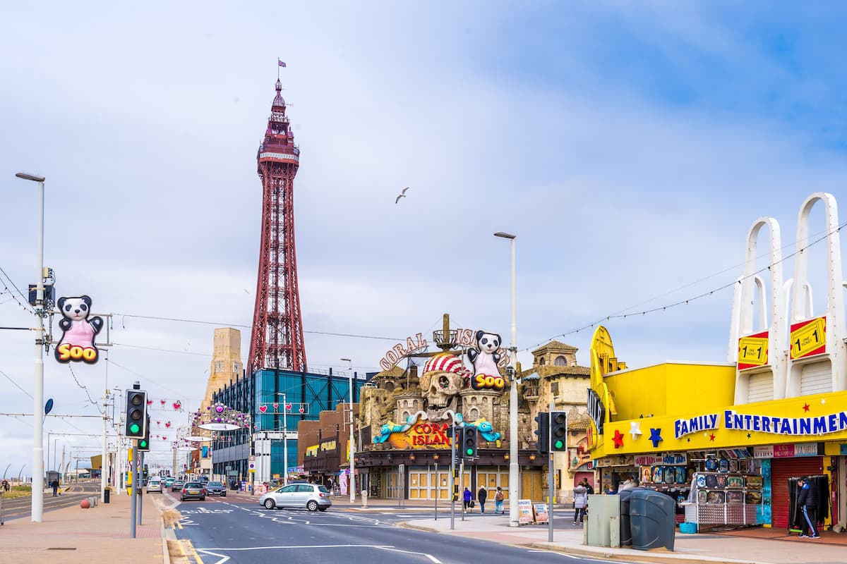A street with a tall red tower, a building with a panda sign, and a yellow Family Entertainment Center.