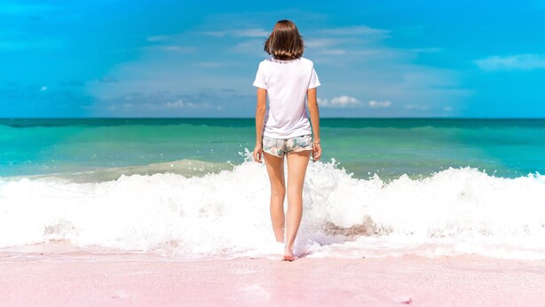 A person standing on a beach with waves in the background. - Empire Blackpool Apartments - 2 St Pauls Road (Blackpool)