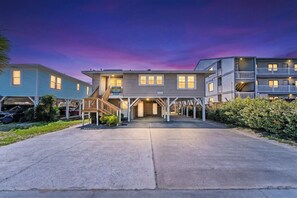 A multi-story hotel with a central entrance, a covered walkway, and a parking area. - Covington Cottage, Oceanfront Cherry Grove Home (North Myrtle Beach)