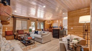 A log cabin interior with a living room, dining area, and kitchen. - Abode at Black Bear #151, remodeled, hot tub, steps to Deer Valley (Park City)