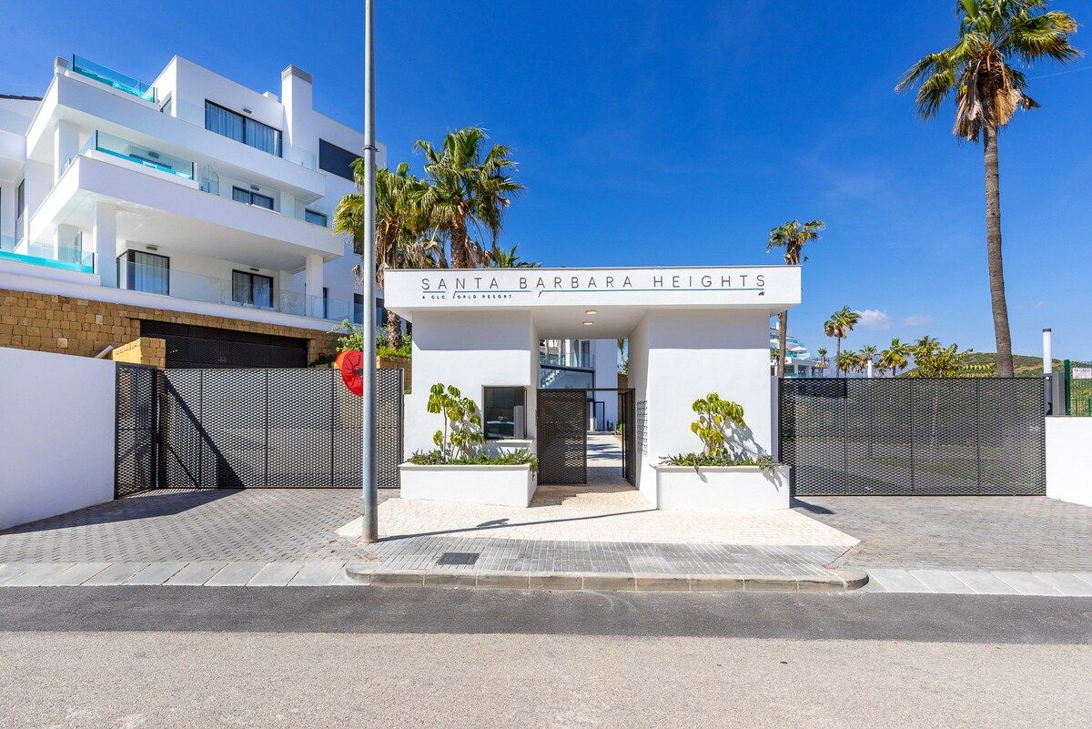 Une entrée d’hôtel moderne, avec une enseigne indiquant « Santa Barbara Heights ».