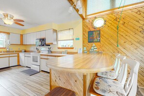 Enjoy cooking in this well-equipped kitchen with a central island and oven.