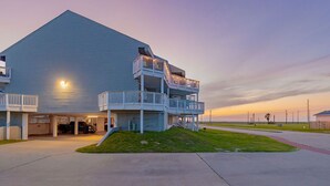 A large, single-story building with a flat roof and a covered front porch. - ⭐⭐⭐⭐⭐ BEAUTIFUL OCEAN VIEWS + Huge Deck + Heated Pool + Hot tub + Boardwalk  (Port Aransas)