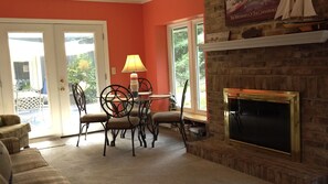 Smart TV, fireplace, books, computer monitors