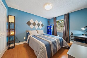 Enjoy a restful stay in this cozy room with a neatly made bed, desk, and bookshelf.