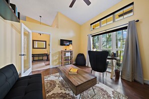Relax in this inviting living space with a sofa, chair, and flat-screen TV.
