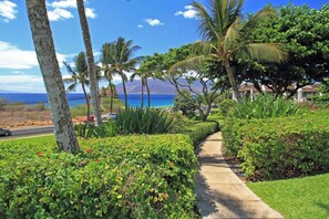 Stroll through lush gardens to a serene coastal retreat.