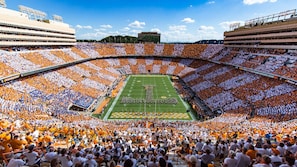 A stadium with tiered seating, a football field, and a large crowd. - Little Joe Log Cabin, UTK/Neyland, Smokies, 16acres, FP, HotTub, Fishing, Pets (Knoxville)