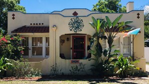 A house with a sun motif on the facade, a small window, and a door. - Close to Downtown, LECOM Field, AMI Beaches and more (Bradenton)