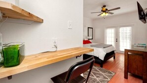A compact bedroom with a bed, a desk, and a chair. - Close to Downtown, LECOM Field, AMI Beaches and more (Bradenton)