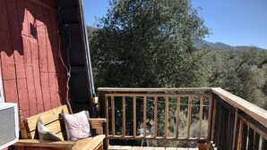 A wooden deck with a bench and potted plants, overlooking a mountainous landscape. - The Barn, mini petting zoo mid term 1-6 month stays  (Warner Springs)