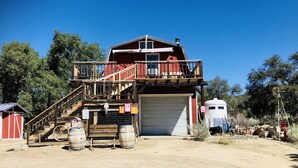 A two-story building with a balcony, a garage, and a silo. - The Barn, mini petting zoo mid term 1-6 month stays  (Warner Springs)