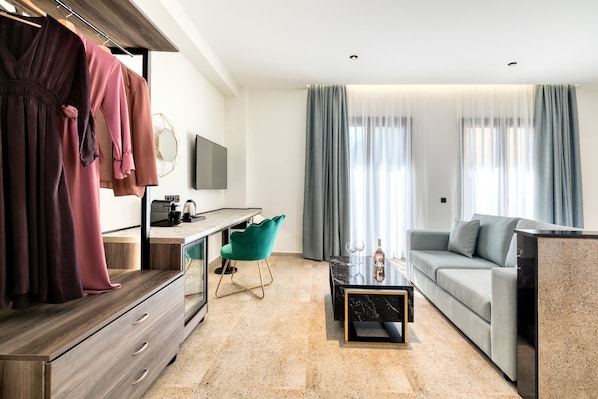 A modern living room with a sofa, a coffee table, and a TV mounted on the wall.