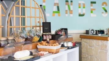 A buffet setup with various food items and condiments, a coffee machine, and a decorative wooden structure.