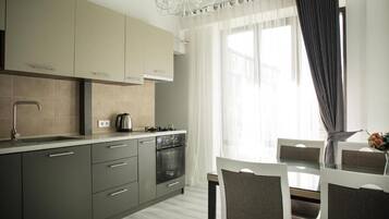 Deluxe Apartment, 2 Bedrooms | Private kitchen | Full-sized fridge, microwave, oven, coffee/tea maker