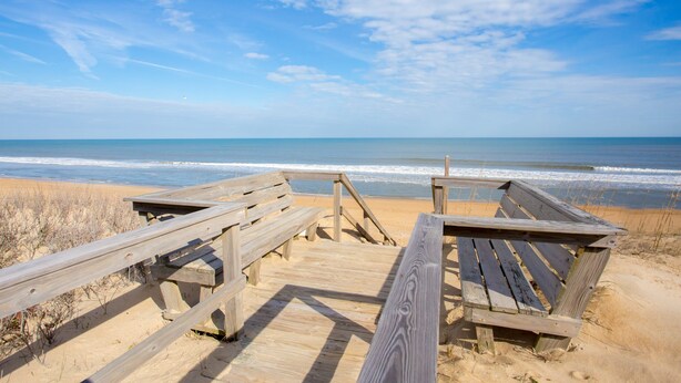 A wooden boardwalk leading to a sandy beach with the ocean in the background. - CheckMate: Walk to Beach, Large Pool, Hot Tub (Southern Shores)
