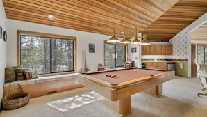 A pool table in a room with wooden ceiling and large windows. - 8 Crag Home with Private Indoor Hot Tub, Bike is Provided for Outdoor Activities by RedAwning (Bend)