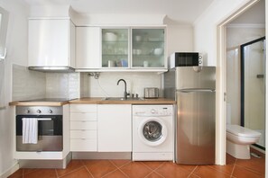 Fridge, microwave, cookware/dishes/utensils, dining tables