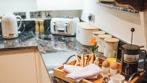 A breakfast tray with eggs, a coffee pot, and a rose on a marble countertop. - Sycamore Barn - UK33353 (Northowram, near Halifax)