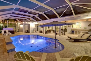 An indoor swimming pool with a glass ceiling, surrounded by lounge chairs and a bar area. - Luxe Modern Design 5000sf/Heated pool/Gameroom (Hollywood)