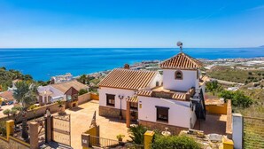 A coastal building with a tiled roof, a satellite dish, and a view of the sea. - Villa Benizan Private Pool, Sea Views, A/C, WiFi (Torrox)