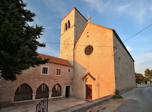 A church with a bell tower and a brick facade.