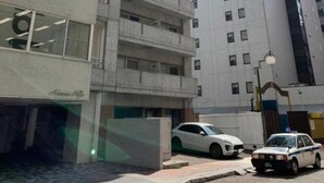 Un edificio de varios pisos con un diseño arquitectónico moderno, que cuenta con balcones y ventanas amplias.