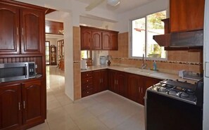 Fridge, stovetop, cookware/dishes/utensils, dining tables