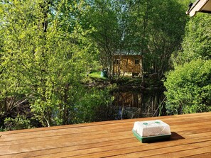 A wooden deck with a small table and a box of ice cream. - Coastal Farm Cottage (Tiverton)