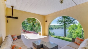 A covered outdoor seating area with a view of a lake and trees. - Yellowhammer Hill - Amenities galore! Near Cullman (Cullman)