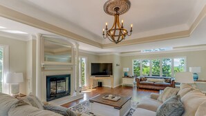 A spacious living room with a fireplace, a large TV, and comfortable seating. - Yellowhammer Hill - Amenities galore! Near Cullman (Cullman)