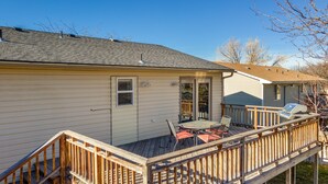 A house with a deck, a covered patio, and a garage.