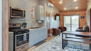 A modern kitchen with stainless steel appliances, grey cabinets, and a wooden ceiling. - The 4th Overlook Seeps 4, In-between Crystal Mountain and Traverse City! WI-FI  (Interlochen)
