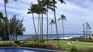 A swimming pool with a view of the ocean and palm trees. - POIPU - ENJOY THE VIEWS!   
MANUALOHOA #506  w/NEW SPLIT A/C SYSTEM (Koloa)