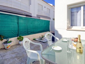 Enjoy a romantic meal for two on this intimate patio, complete with a glass table and comfortable seating.