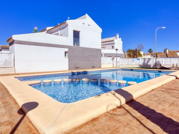 Relax by the pool surrounded by a spacious deck and comfortable poolside seating.