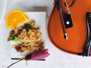 A violin on a white table with a plate of food and a flower. - Acheron Valley Country Estate (Acheron)