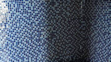 Cozy seating area with a bench against the wall, surrounded by a visually appealing tile pattern.
