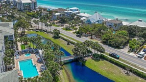 A coastal hotel with a swimming pool, a bridge, and a view of the ocean. - Private Beach, Pickleball, Tennis 3 heated pools! (Santa Rosa Beach)