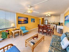 A living room with a television, a dining area, and a kitchenette. - Kamaole Sands #9-111 Family-Friendly Suite Near Famous Kamaole III Beach (Kihei)