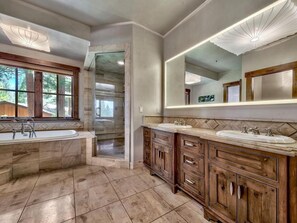 A spacious bathroom with a large bathtub, two sinks, and a walk-in shower. - Lake View 545 Lodgepole | 6BR/6.5BA Incline | Hot Tub, Game Room (Incline Village)