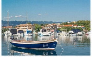 Moored boats and serene waters create a tranquil atmosphere.