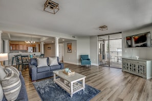 Relax in a spacious living area with a sofa set, armchair, and coffee table, perfect for unwinding.