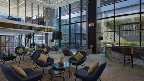 A spacious lobby with modern seating, large windows, and a high ceiling. - Anara Airport Hotel (Tangerang)